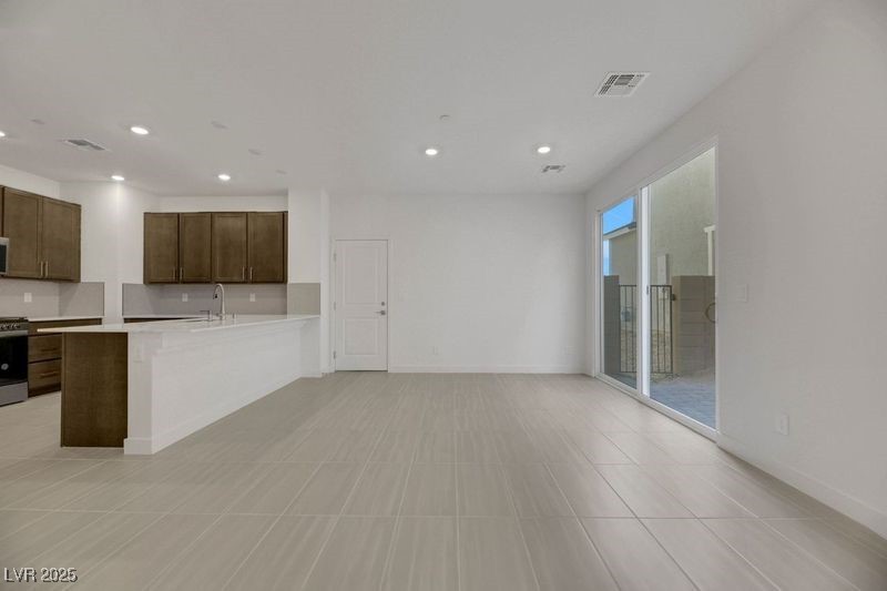 2770 Alfena Place Henderson, NV 89044 - Photo 26 of 26 Kitchen featuring dark brown cabinetry, recessed lighting, appliances with stainless steel finishes, a peninsula, and open floor plan
