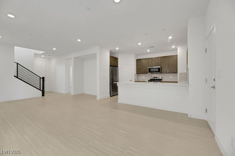 2770 Alfena Place Henderson, NV 89044 - Photo 11 of 26 Unfurnished living room with recessed lighting, stairway, and light tile patterned flooring