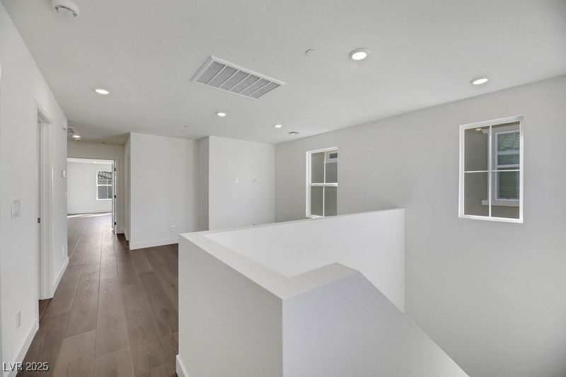 2770 Alfena Place Henderson, NV 89044 - Photo 18 of 26 Hall featuring recessed lighting, dark wood-style floors, and an upstairs landing