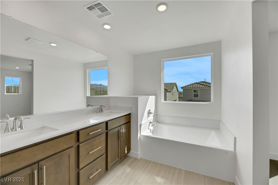 2770 Alfena Place Henderson, NV 89044 - Photo 23 of 26 Bathroom with a bath, double vanity, light tile patterned flooring, and recessed lighting