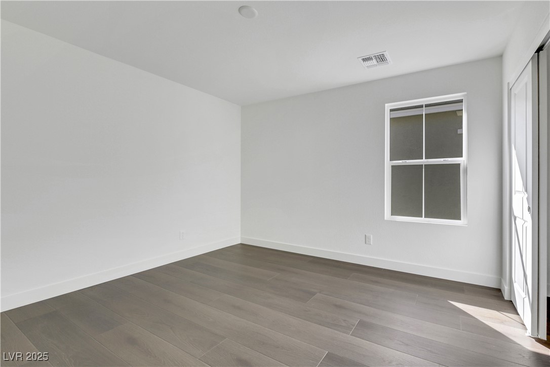 2770 Alfena Place Henderson, NV 89044 - Photo 5 of 26 Unfurnished room featuring dark wood-type flooring and baseboards