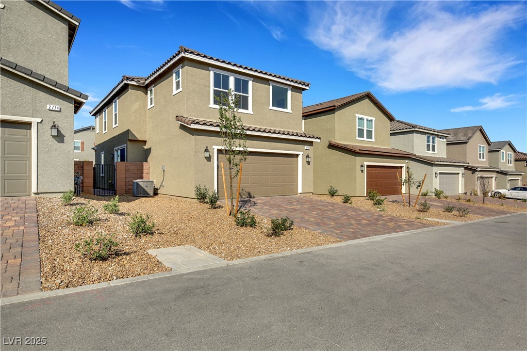 2770 Alfena Place Henderson, NV 89044 - Photo 6 of 26 View of front of property featuring stucco siding, a garage, decorative driveway, a gate, and a tile roof