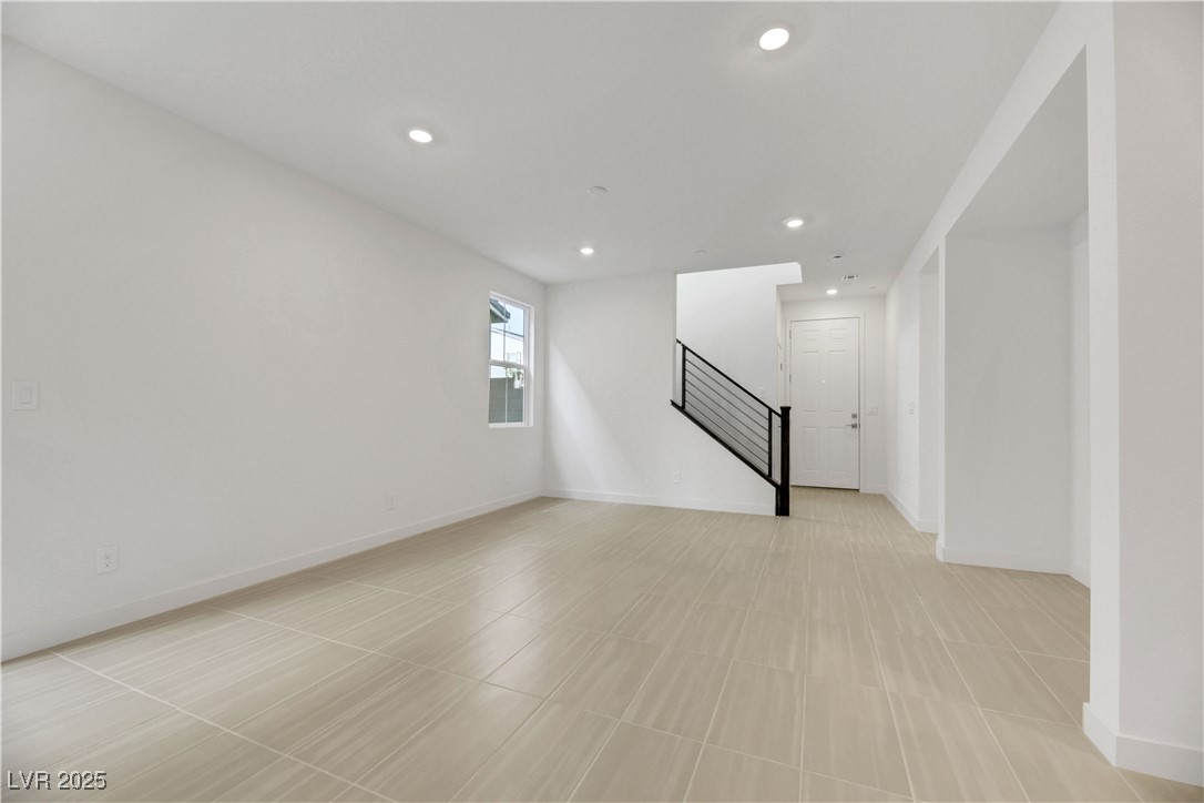 2770 Alfena Place Henderson, NV 89044 - Photo 8 of 26 Unfurnished living room with stairs, recessed lighting, and light tile patterned floors