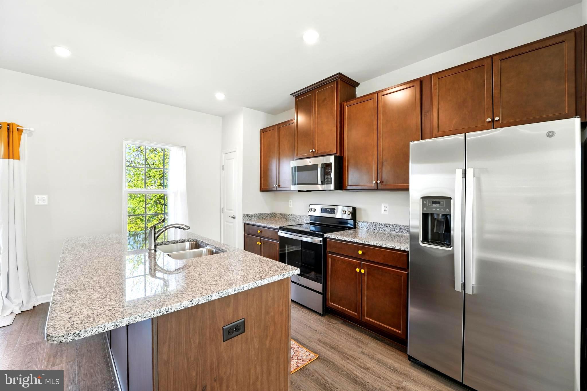 1754 Scenic Loop Culpeper, VA 22701 - Photo 5 of 39 a kitchen with stainless steel appliances granite countertop a refrigerator a stove a sink and a microwave