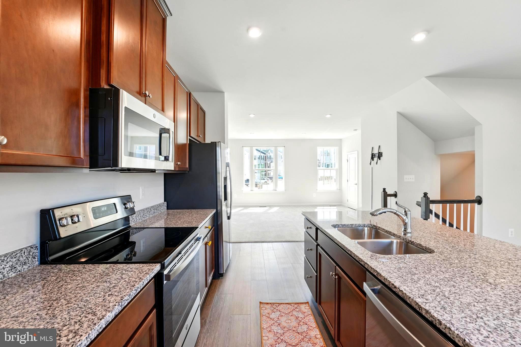 1754 Scenic Loop Culpeper, VA 22701 - Photo 6 of 39 a kitchen with stainless steel appliances granite countertop a sink a stove and a wooden cabinets