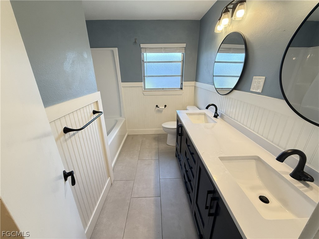 1534 Ricardo Avenue Fort Myers, FL 33901 - Photo 11 of 22 a bathroom with a sink and a mirror