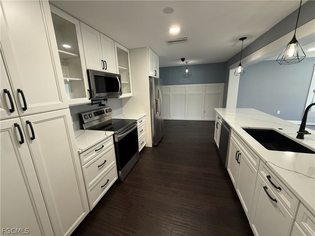 1534 Ricardo Avenue Fort Myers, FL 33901 - Photo 7 of 22 a kitchen with cabinets appliances and a sink