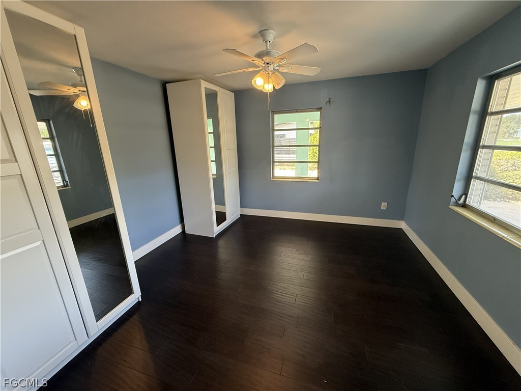 1534 Ricardo Avenue Fort Myers, FL 33901 - Photo 8 of 22 an empty room with wooden floor and windows
