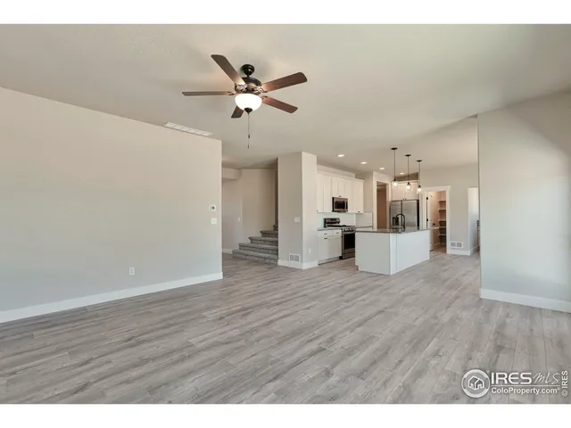 a view of an empty room and wooden floor
