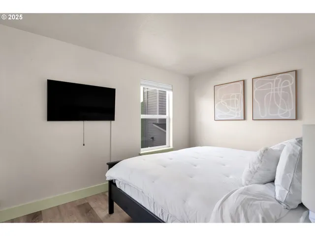 a bedroom with a bed and a flat screen tv