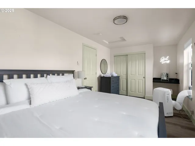a large white bed in a white room