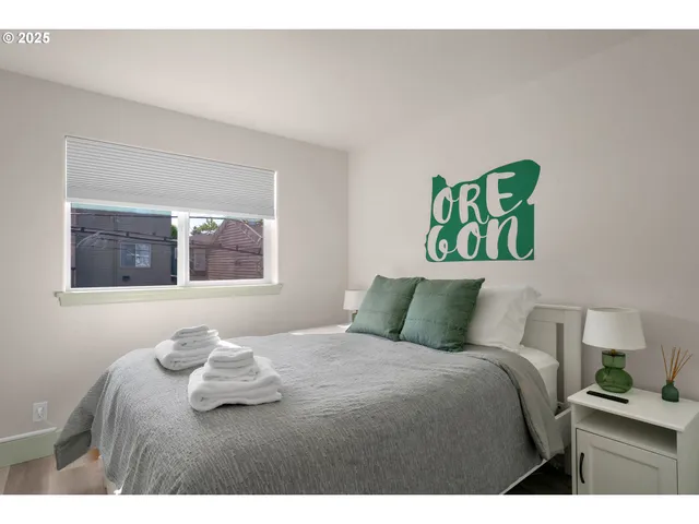 a bedroom with a bed and a painting on the wall