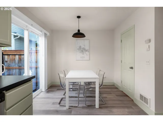 a dining room with furniture and wooden floor