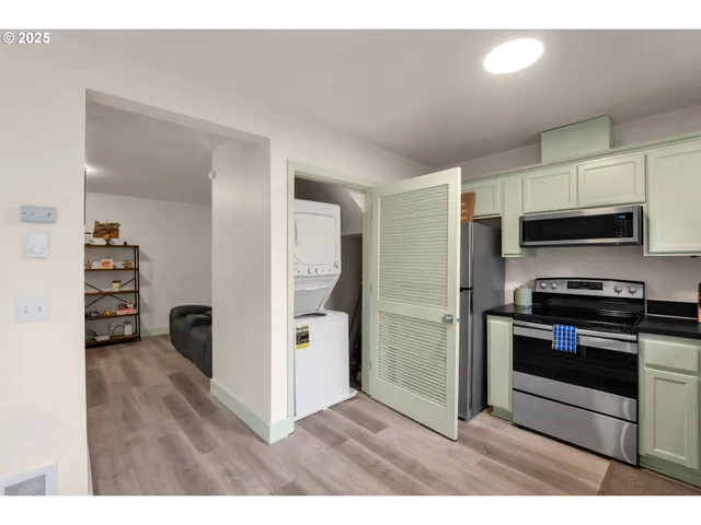 a kitchen with stainless steel appliances kitchen island granite countertop a refrigerator and a stove top oven