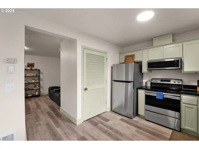 a kitchen with stainless steel appliances a stove a microwave and a refrigerator