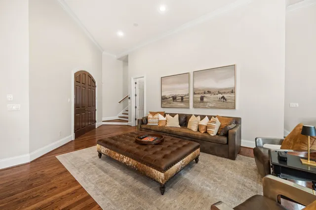 a living room with furniture ceiling fan and a large window