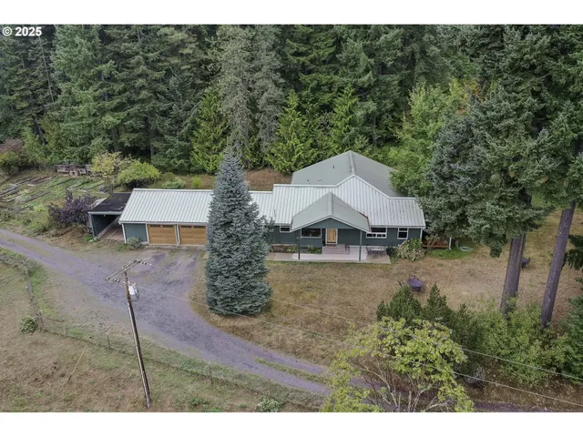 a view of a house with a yard and street