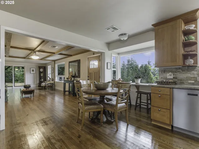 a very nice looking dining room with a large window and breakfast area