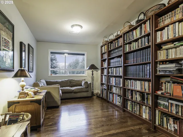 a living room with furniture and a book shelf