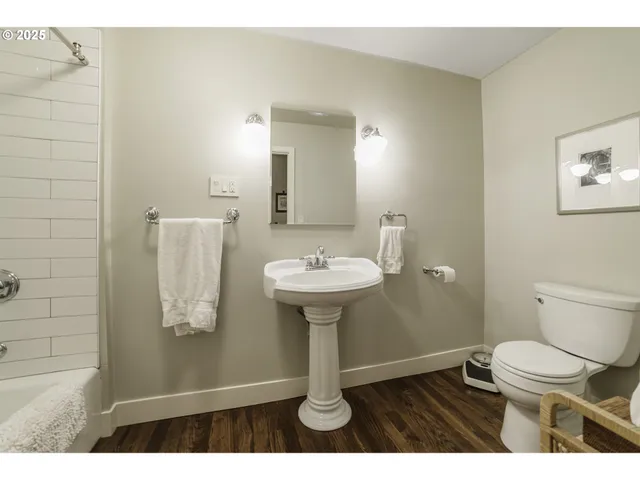 a bathroom with a sink toilet and a mirror