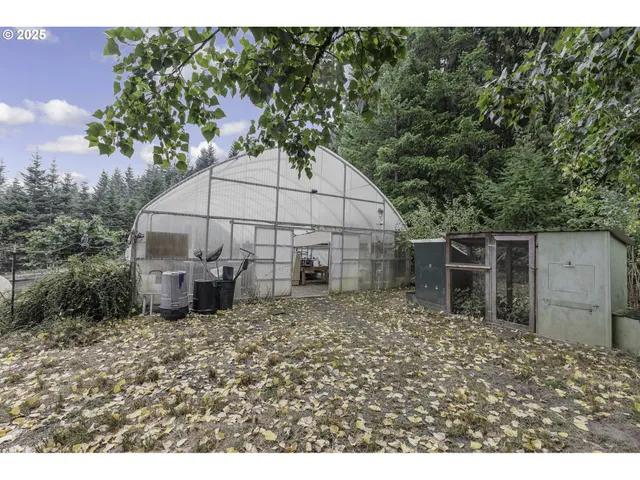 a backyard of a house with table and chairs under an umbrella