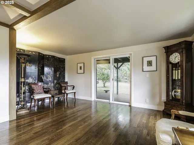 a living room with furniture window and wooden floor