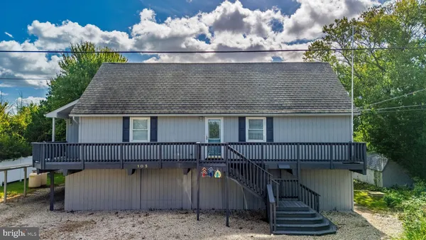a view of a house with wooden fence