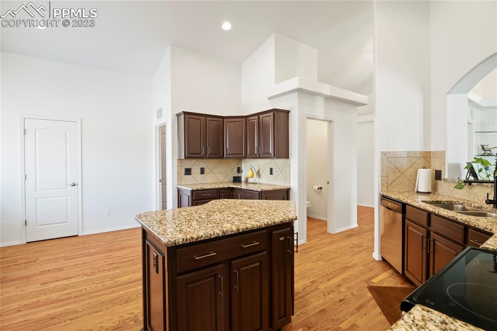 10658 Pictured Rocks Drive Peyton, CO 80831 - Photo 11 of 36 a kitchen with stainless steel appliances granite countertop a sink stove and refrigerator