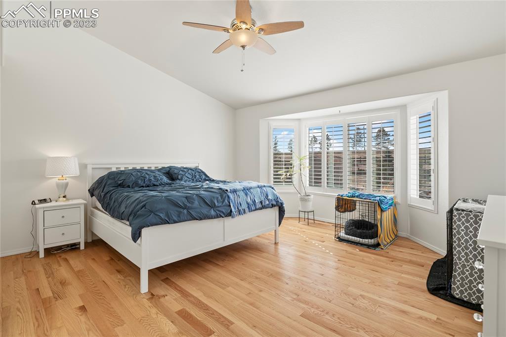 10658 Pictured Rocks Drive Peyton, CO 80831 - Photo 15 of 36 a spacious bedroom with a bed and wooden floor