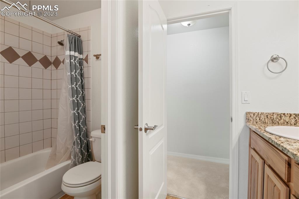 10658 Pictured Rocks Drive Peyton, CO 80831 - Photo 28 of 36 a bathroom with a shower curtain a sink and a toilet
