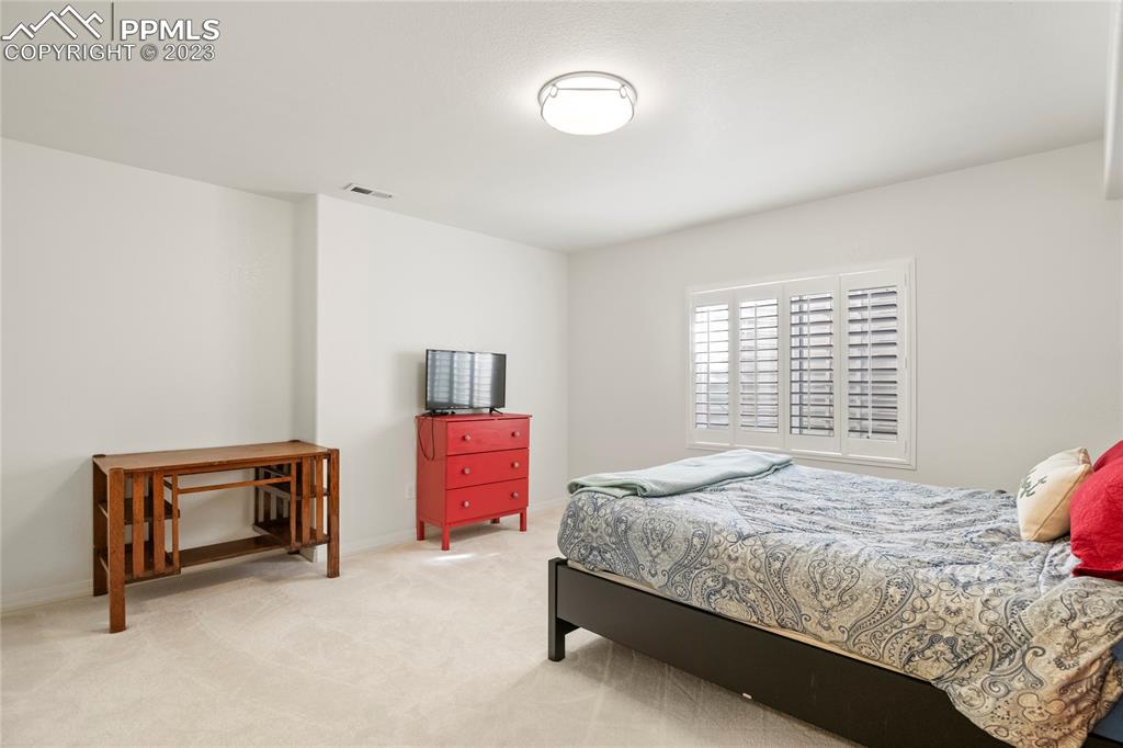 10658 Pictured Rocks Drive Peyton, CO 80831 - Photo 30 of 36 a bedroom with a bed and a dresser in it
