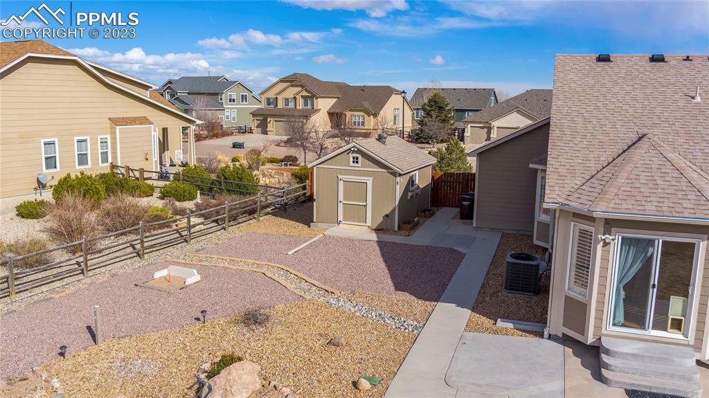 10658 Pictured Rocks Drive Peyton, CO 80831 - Photo 35 of 36 a view of a white house with a big yard and potted plants