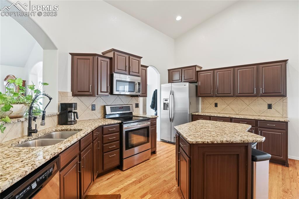 10658 Pictured Rocks Drive Peyton, CO 80831 - Photo 9 of 36 a kitchen with a sink refrigerator and microwave
