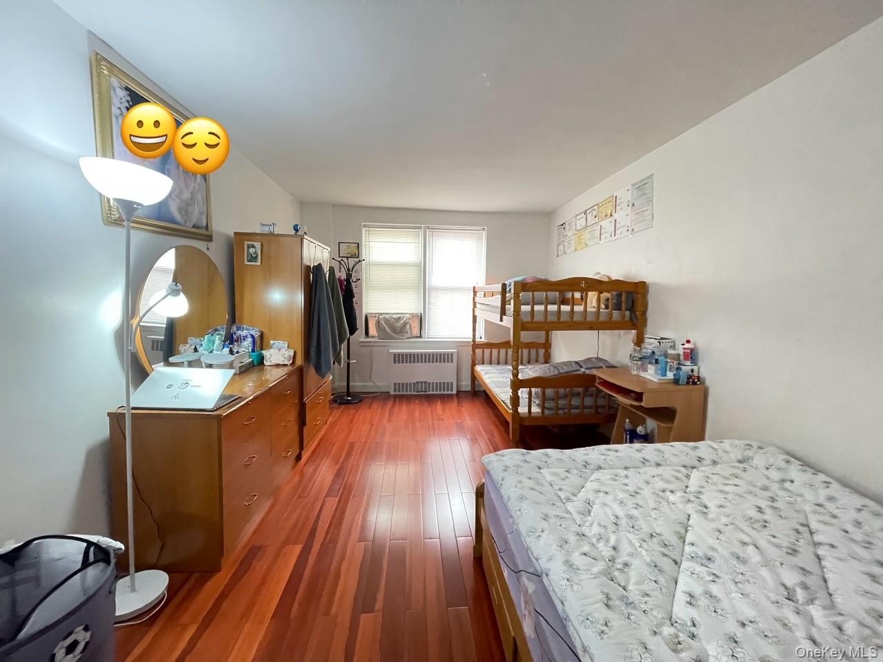 43-35 Union Street, Unit 2M Queens, NY 11355 - Photo 5 of 13 a bedroom with a bed and wooden floor
