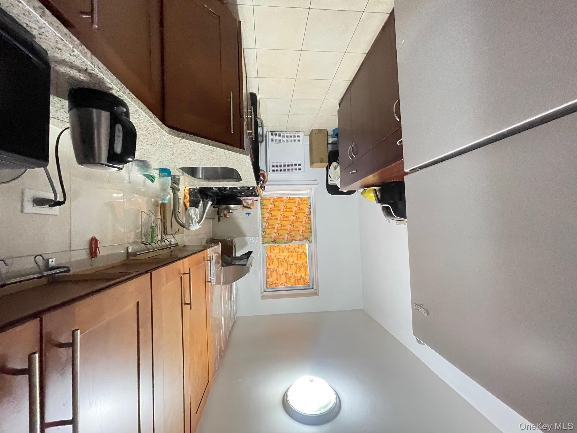 43-35 Union Street, Unit 2M Queens, NY 11355 - Photo 7 of 13 a kitchen with stainless steel appliances granite countertop a sink stove and refrigerator