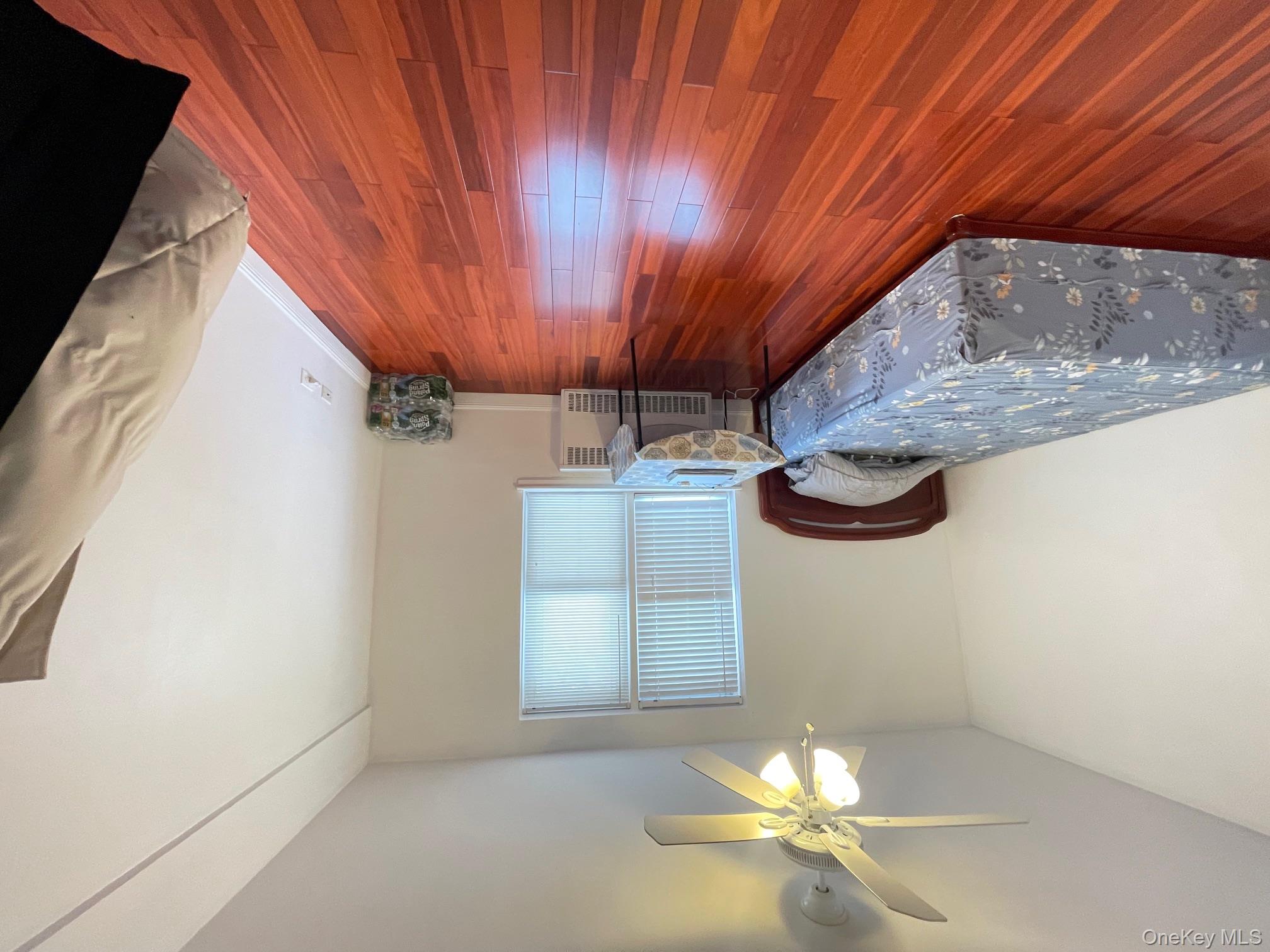 43-35 Union Street, Unit 2M Queens, NY 11355 - Photo 8 of 13 a bedroom with a bed and a ceiling fan