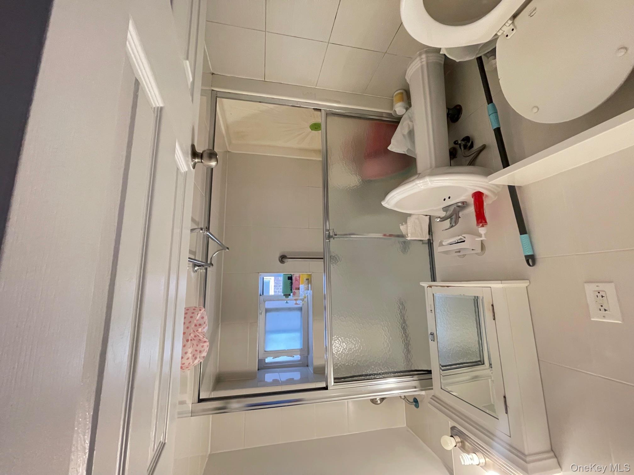 43-35 Union Street, Unit 2M Queens, NY 11355 - Photo 10 of 13 a bathroom with a sink toilet and shower
