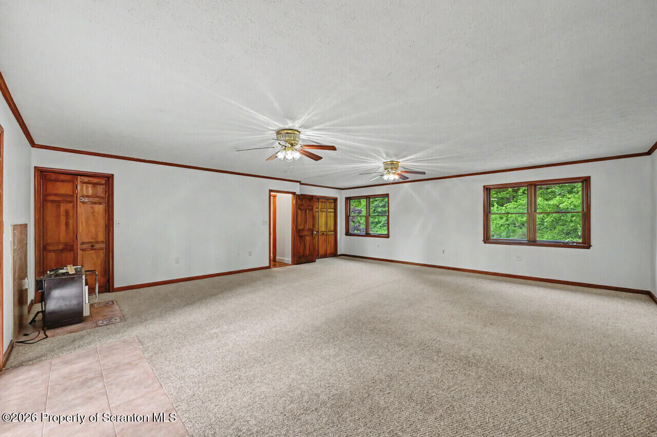 211 Buckingham Street Moscow, PA 18444 - Photo 39 of 83 an empty room with windows and chandelier