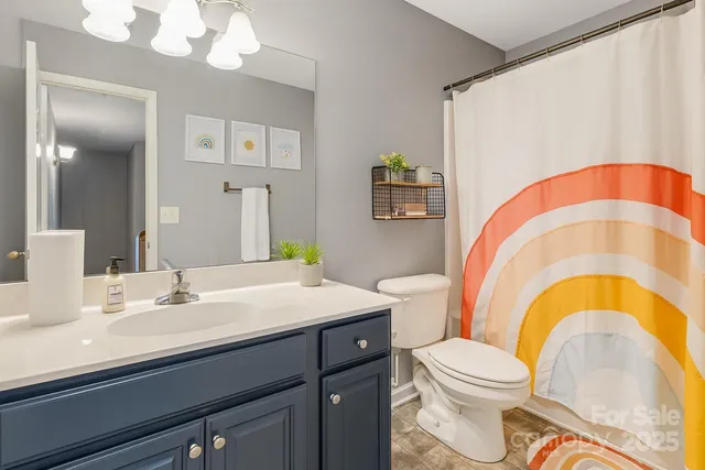 a bathroom with a sink a toilet and a mirror