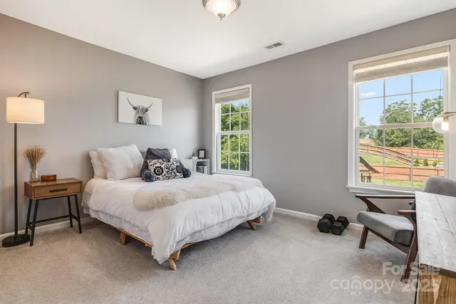 a spacious bedroom with a bed and a window