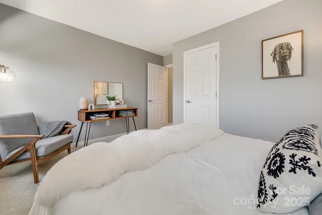 a bedroom with a bed and a chair