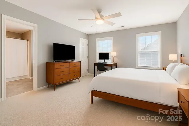 a bedroom with a bed and a flat screen tv