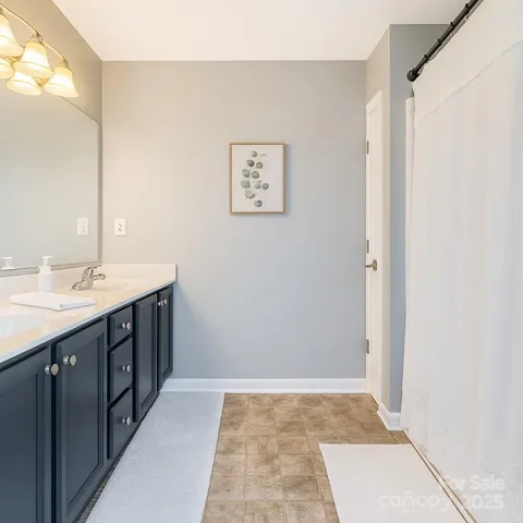a bathroom with a double vanity sink and a mirror