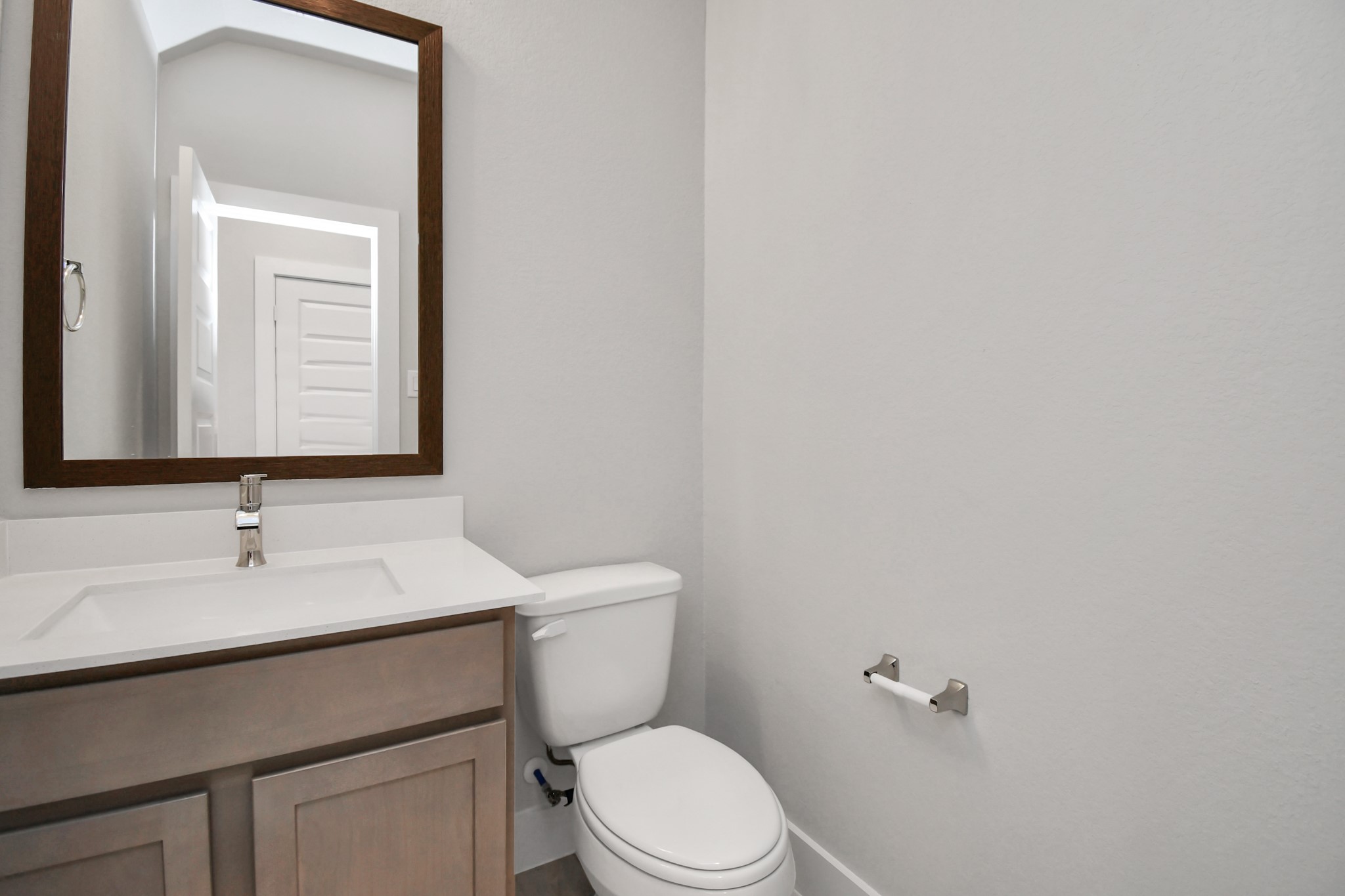 3043 Native Spg Drive Spring, TX 77373 - Photo 10 of 39 Delightful half bathroom featuring a sophisticated 5-panel door, upgraded sink, contemporary hardware, and bright recessed lights. Sample photo of completed home with similar floor plan. Actual colors and selections may vary.