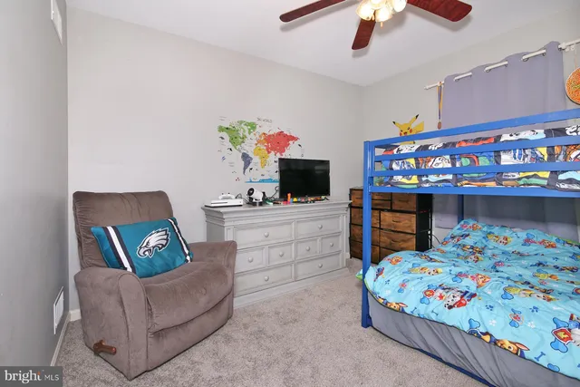 a bedroom with furniture and a wooden floor