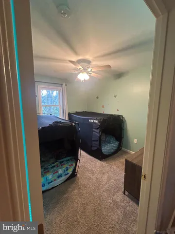 a view of a livingroom with furniture and a ceiling fan