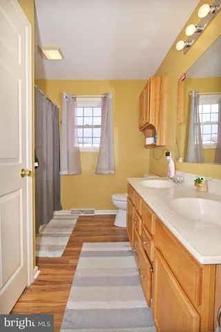 a spacious bathroom with double vanity and a bathtub