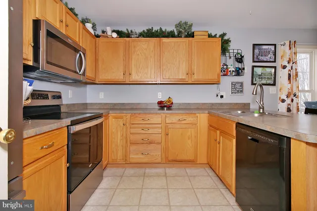 a kitchen with stainless steel appliances granite countertop a sink and cabinets