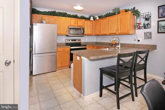 a kitchen with a refrigerator a microwave a sink and a stove