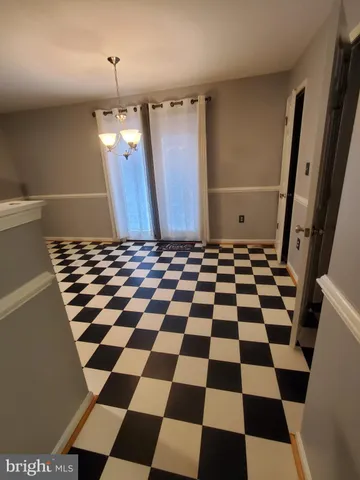 a bathroom with a black and white checkered floor